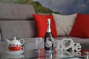 里沃的住宿－Apartament Ibiza przy plaży，一瓶香槟和一张桌子上的两杯酒