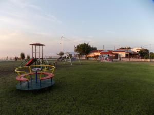 einen Spielplatz mit Rutsche in einem Park in der Unterkunft Athina Apartments in Palaiopoli