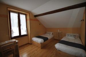 Postel nebo postele na pokoji v ubytování Auberge du Hérisson