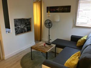 a living room with a couch and a coffee table at Lespinet in Toulouse