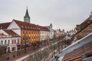 a city street with buildings and a clock tower at Amiss Apartments in Košice