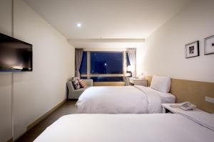 Voodi või voodid majutusasutuse Wemeet Hotel Taipei toas