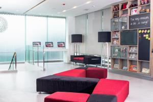 a living room with a red and black couch at Red Planet Manila Bay in Manila