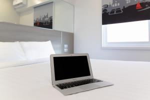 a laptop computer sitting on a table in a room at Red Planet Manila Bay in Manila