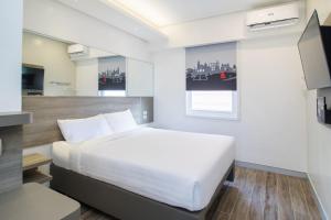 a bedroom with a large white bed in a room at Red Planet Manila Bay in Manila