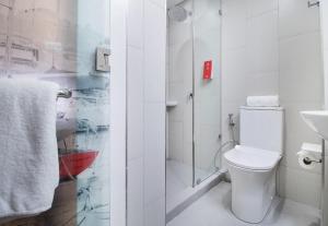 a bathroom with a toilet and a shower at Red Planet Manila Bay in Manila