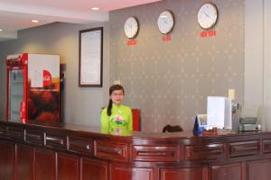 a woman standing at a cash counter in a store at Lam Son Hotel in Vung Tau