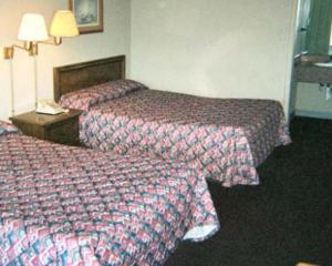 a hotel room with two beds and a phone at Royal Extended Stay in Alcoa