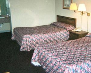 a hotel room with two beds and a telephone at Royal Extended Stay in Alcoa