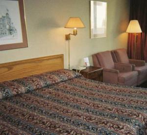 a hotel room with a bed and a couch at Royal Extended Stay in Alcoa