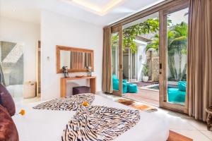 a room with a zebra print bed and a sliding glass door at Villa Safari in Seminyak +58 photos
