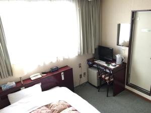Una cama o camas en una habitación de Green Hill Hotel Tennoji Ekimae