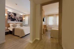 a hotel room with two beds and a large mirror at Sealife Family Resort Hotel in Antalya