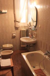 a bathroom with a tub and a sink and a toilet at Domus Angela B&b in Trani