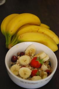 a bowl of fruit with bananas and strawberries at Manor Farm Stay in Sutton on Sea