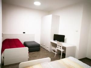 a bedroom with a bed and a desk with a computer at Residenza Borgazzi in Monza