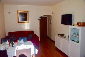 a living room with a red couch and a tv at Cuore di Roma Apartment in Rome