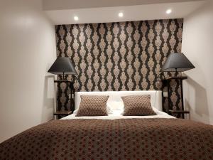 Postelja oz. postelje v sobi nastanitve Suite Appart'Hôtel La Loggia By M Spa