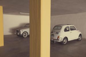 two old white cars parked in a garage at Avantgarde Hotel in Conversano