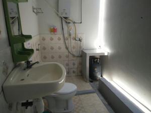 a small bathroom with a sink and a toilet at CF Komodo Hotel in Labuan Bajo