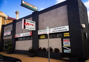 a store with signs on the side of a building at City Centre Motel Hotel in Port Pirie