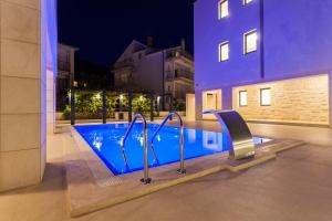 a swimming pool in the middle of a building at Villa Unique 9 in Podstrana