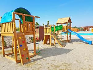a group of playground equipment in the sand at Miraj Resort in Lučenec