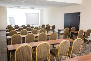 a conference room with tables and chairs and a whiteboard at Miraj Resort in Lučenec +51 photos
