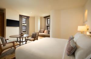 a hotel room with a bed and a table at Alila Fort Bishangarh Jaipur - A Hyatt Brand in Jaipur