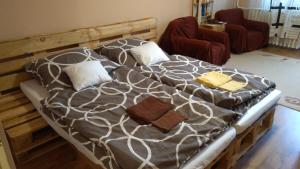 a large bed in a living room with at Gesztenyés Apartman in Miskolc