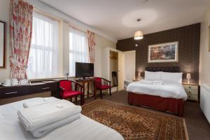 Ένα ή περισσότερα κρεβάτια σε δωμάτιο στο Maples Hotel