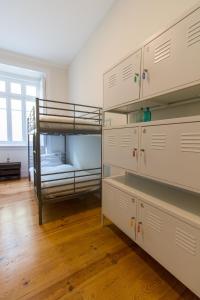 a bedroom with two bunk beds and wooden floors at Change The World Hostels - Cascais - Estoril in Monte Estoril