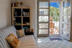 a living room with a couch and a sliding glass door at Bargujac Summer House in Vis
