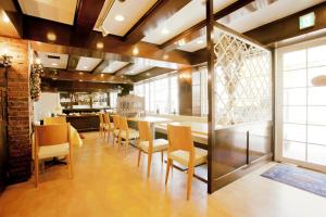 a dining room with a table and chairs at Shimizu City Hotel in Shizuoka