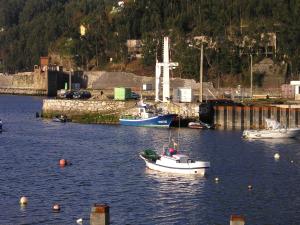 a group of boats in a body of water at Casa Camilo in San Juan de la Arena