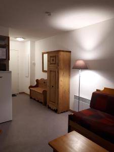 a living room with a bed and a dresser in a room at " B18 " T2-5p de standing au pied des pistes de Superdévoluy - "résidence Les Toits du Dévoluy" - Vue Magnifique - classé PMR in Le Dévoluy