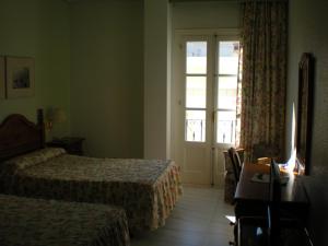 a hotel room with two beds and a window at Hotel Terraza Carmona in Vera