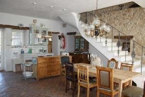 a kitchen and dining room with a table and a staircase at Terra Mirna - Urlaub für die Sinne in Vižinada
