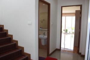 a bathroom with a sink and a toilet and a staircase at Uncle House Krabi in Krabi