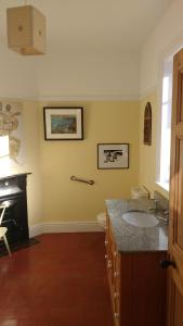 a bathroom with a sink and a fireplace at Beech Hill B&B in Northwich