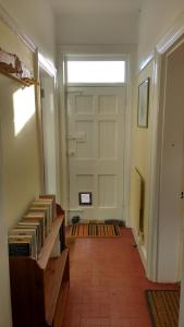 a room with a door and a bunch of books at Beech Hill B&B in Northwich