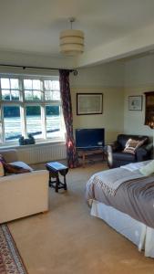 a living room with a bed and a couch at Beech Hill B&B in Northwich