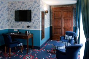 Télévision ou salle de divertissement dans l'établissement Carlton Ambassador