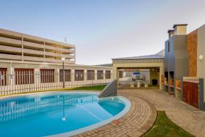 a large swimming pool in front of a building at Diaz Hartenbos in Diasstrand