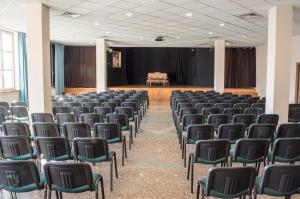 an empty room with chairs and a stage at Amicus Żoliborz in Warsaw