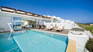 a villa with a swimming pool and a patio at Luxury Bay View Villa 28 Right On The Beach in Protaras