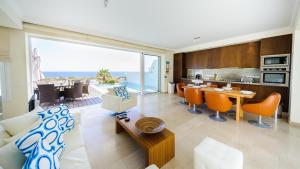a living room with a kitchen and a dining room at Luxury Bay View Villa 28 Right On The Beach in Protaras