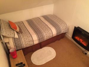 a room with a fire place and a bed at Melrose Guest House in Whitley Bay