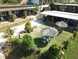 an aerial view of a house with umbrellas in the yard at Cat Bungalow in Ko Lanta