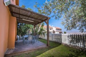 a wooden deck with a table and chairs at Adi in the desert in Arad